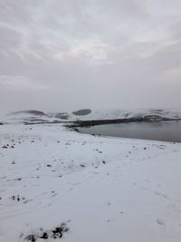 Scenic view of sea against sky during winter