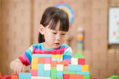 Portrait of cute boy with toy on table