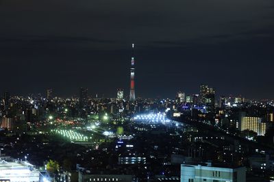 Illuminated buildings against sky at night