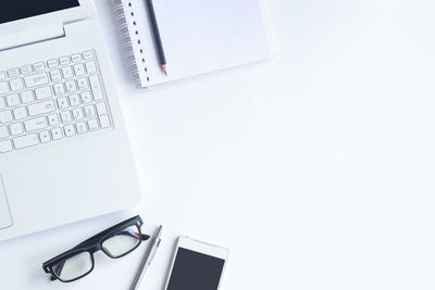 High angle view of office supplies on white background