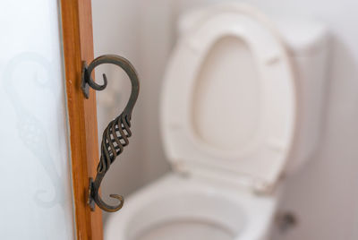 Close-up of door handle at toilet entrance