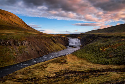 Scenic view of landscape against cloudy sky