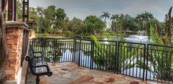 Scenic view of swimming pool by lake against sky