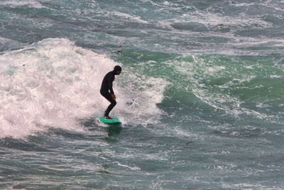 Full length of man surfing in sea