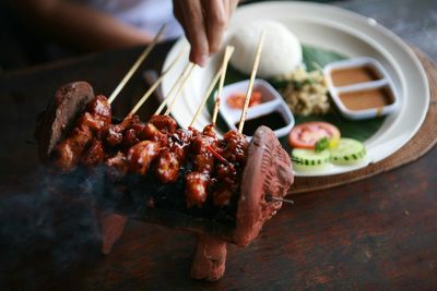 Midsection of person preparing food on table