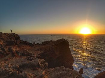 Scenic view of sea against clear sky during sunset