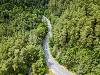 Winding road from high mountain pass, in summer time. aerial view by drone. romania