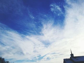 Low angle view of building against cloudy sky