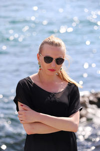 Young woman wearing sunglasses standing outdoors