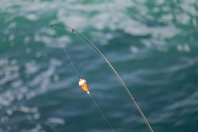High angle view of fishing rod against sea