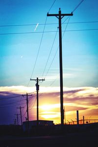 Electricity pylon against sky at sunset