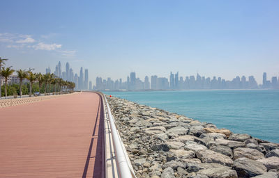 Panoramic view of sea and buildings against sky