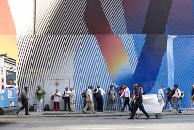 People walking on street in city