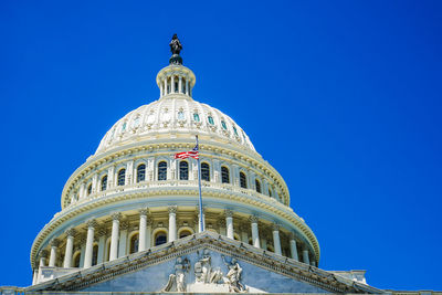 Low angle view of historical building against clear blue sky