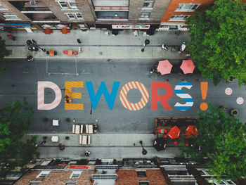 Text on street against buildings in city