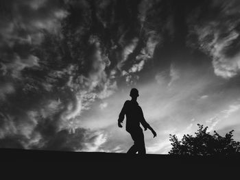 Side view of a silhouette man walking against the sky