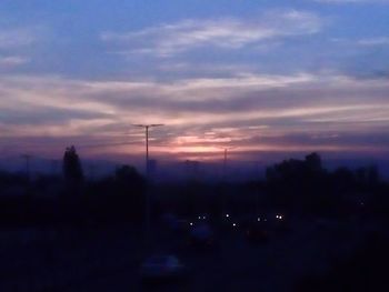 Silhouette trees against sky during sunset