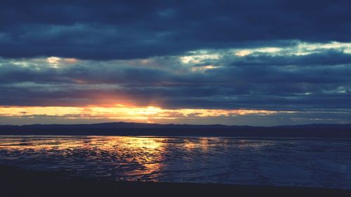 Scenic view of sea against dramatic sky