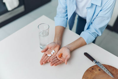 Midsection of doctor examining patient in laboratory