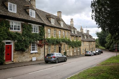 Cars on road by buildings in city