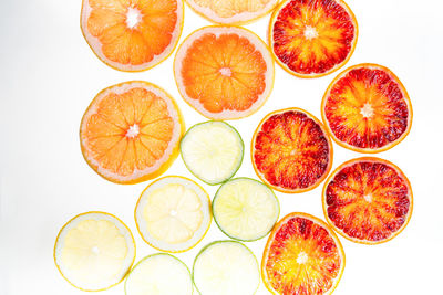 Slices of citrus fruit on white background