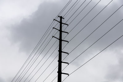 Low angle view of power lines against sky