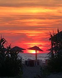 Scenic view of sea against romantic sky at sunset