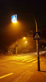 Illuminated road sign at night