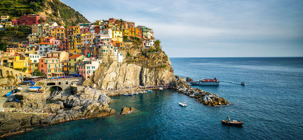 Panoramic view of sea and buildings against sky