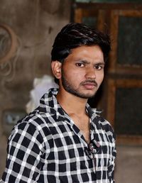 Portrait of young man standing indoors