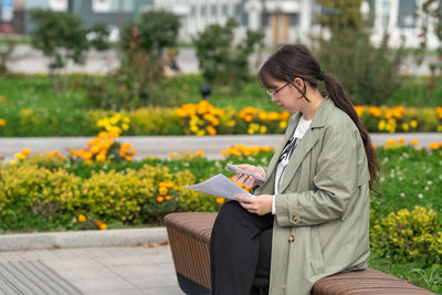 Portrait of young woman standing in park