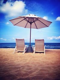 Scenic view of beach against blue sky