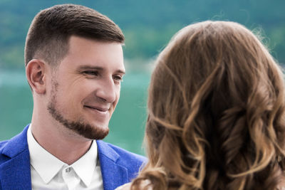 Close-up of man looking at woman outdoors