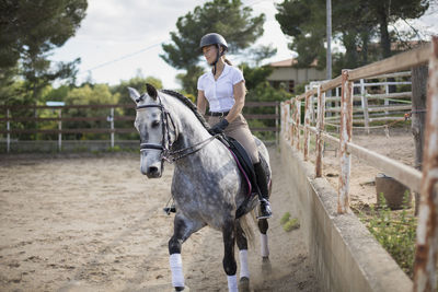 Full length of woman riding horse