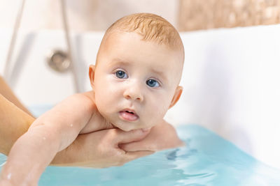 Close-up of baby girl taking bath