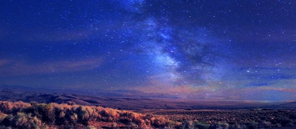 Scenic view of landscape against sky at night