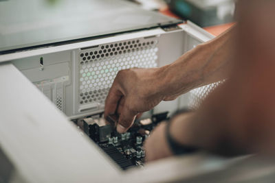 Digital craftsman, engineer hands in action, displaying meticulousof personal computer customization