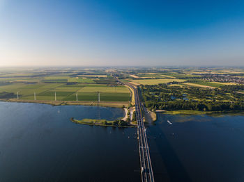 High angle view of river amidst field against sky