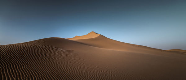 Scenic view of desert against clear sky