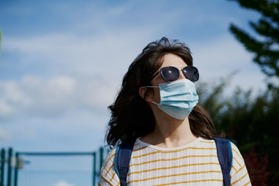Female in medical mask on sports ground