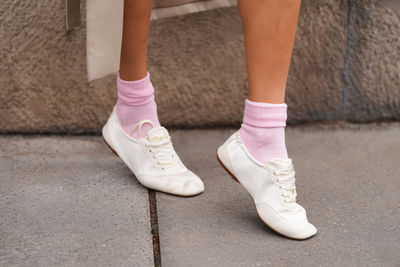 Low section of man standing on road