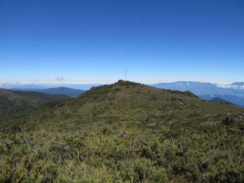 Scenic view of mountains against clear blue sky