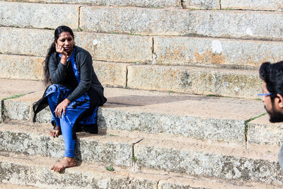 Thoughtful young woman sitting on steps