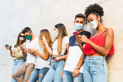 Young couple holding smart phone outdoors