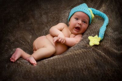 Portrait of cute baby lying on bed