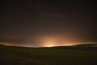 Scenic view of silhouette mountain against sky at night