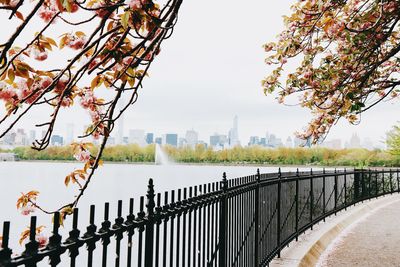 Bridge over river in city against clear sky
