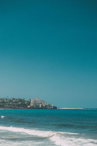 Scenic view of sea against clear blue sky