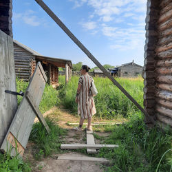 Rear view of woman standing on steps