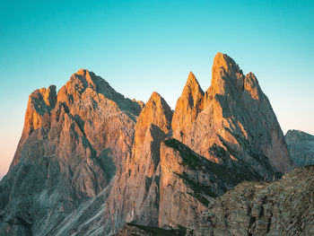 Panoramic view of rocky mountains against clear blue sky